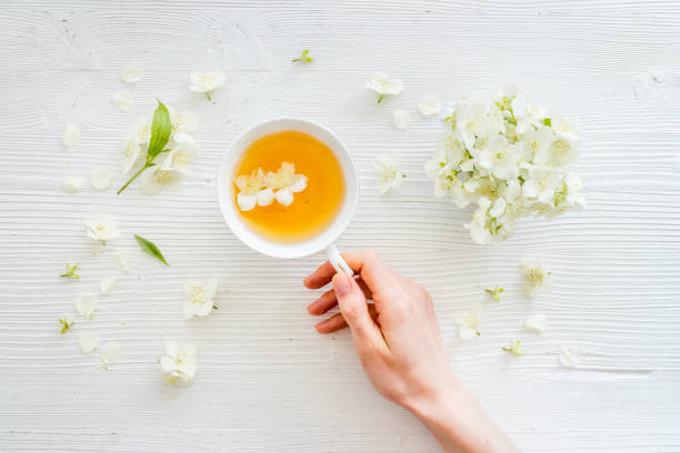 istock Tea in a cup with jasmine flowers. Herbal tea top view 1327619409
