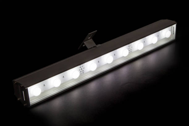 istock Glowing LED flood light bar on black background 1327619440