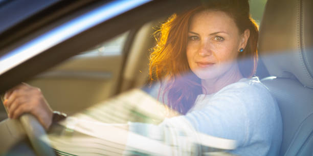 istock Pretty, young woman  driving a car 1327622062