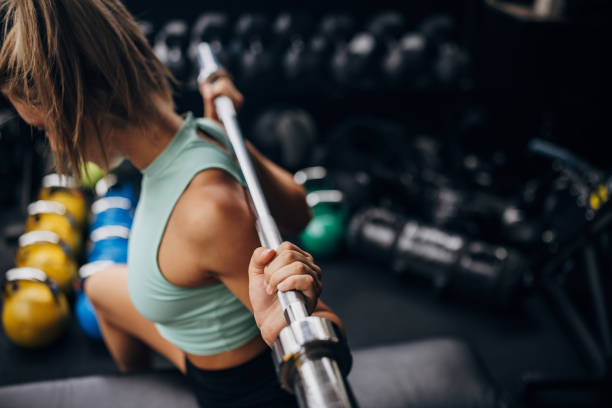 istock Young woman exercising in gym 1327623722
