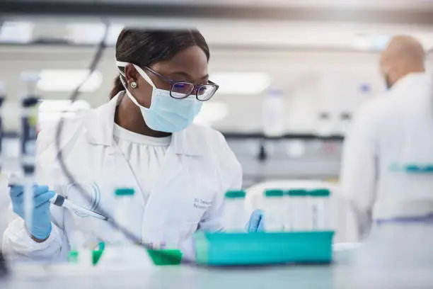 Photo of Shot of a young scientist conducting medical research in a laboratory