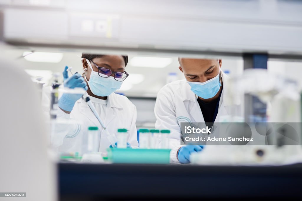 Shot of two young scientists conducting medical research in a laboratory Let's get technical Laboratory Stock Photo