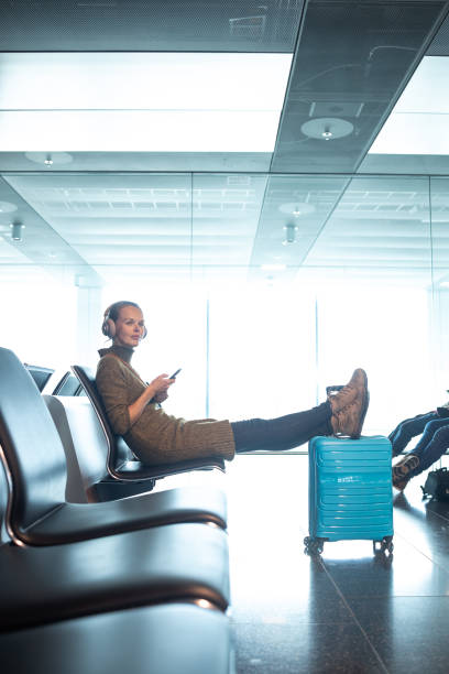 istock A female traveller waiting for her flight boarding time 1327624347