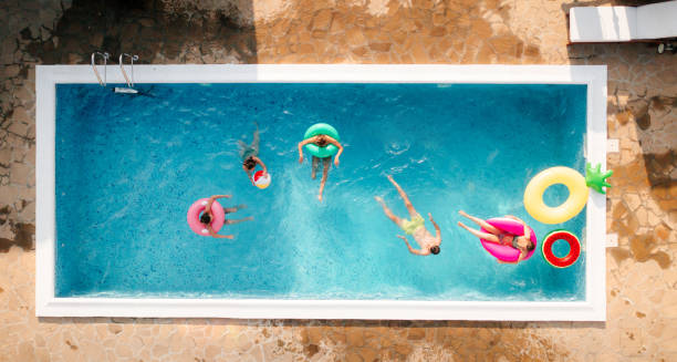 istock Friends having fun in the swimming pool 1327624363