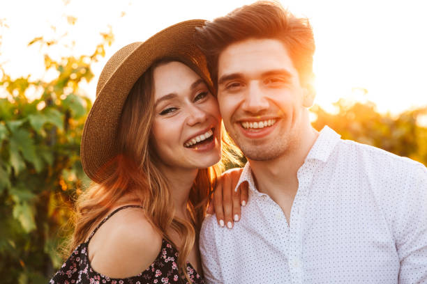 istock Happy loving couple outdoors looking camera. 1327626284