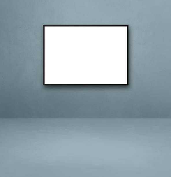 istock Black picture frame hanging on a grey wall 1327626934