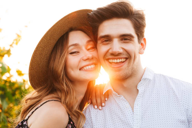 istock Happy loving couple outdoors looking camera. 1327628958