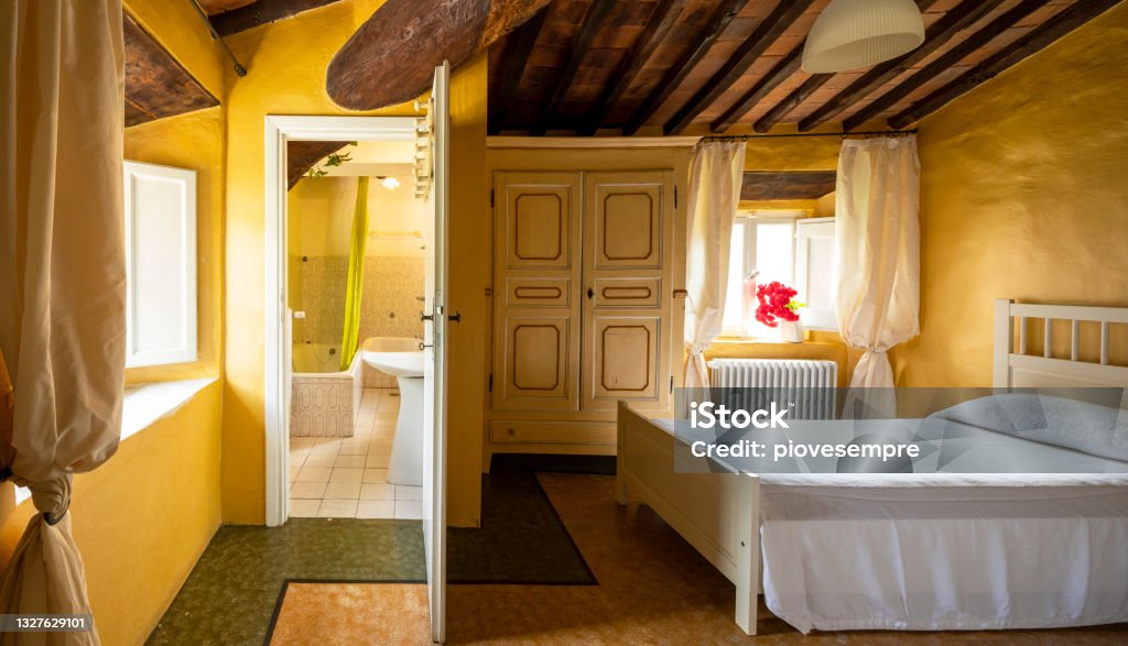 old double bedroom with bathroom inside. Old double bedroom with bathroom inside. The walls are yellow Yellow Stock Photo
