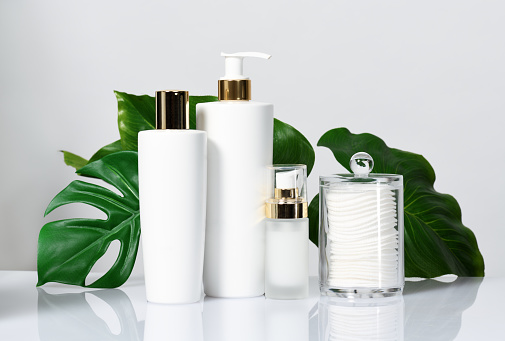 Arrangement of cleansing skin products with leaves