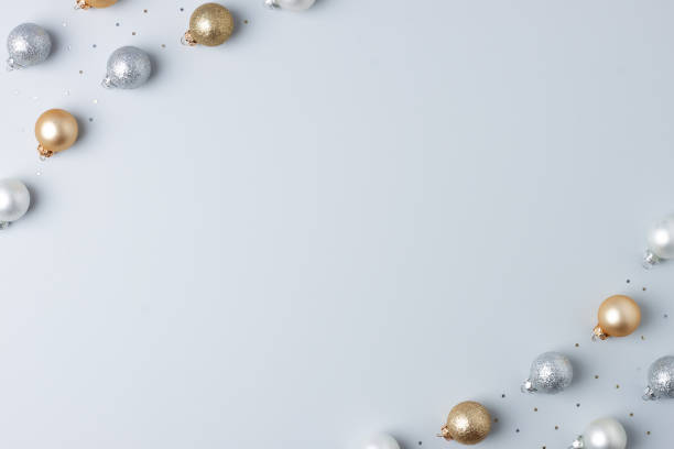 istock Christmas grey minimal background with grey and beige ball and confetti. Flat lay, copy space 1327633542