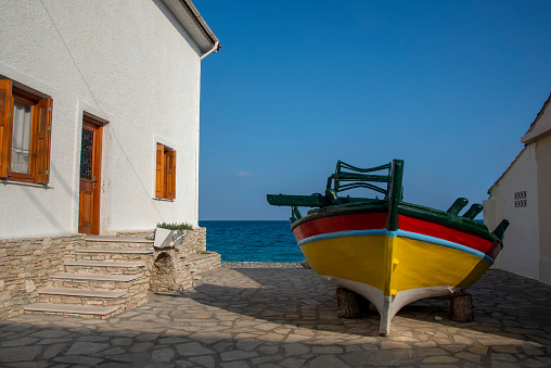 Bright colored fishing boat on the quayside of Kokkari, Samos.
