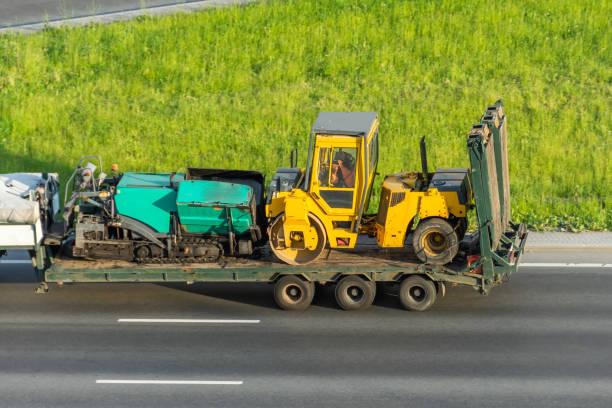 truck carrying oversized machinery along the highway