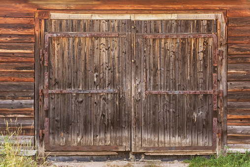 Old and weathered wooden door of abandoned building