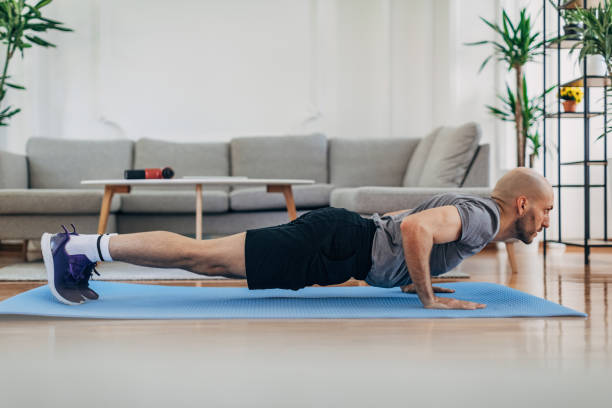 istock Man doing push-ups on the floor at home 1327637456