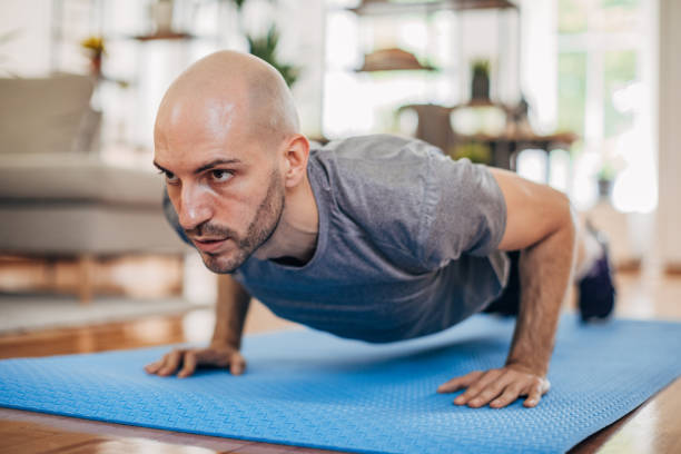 istock Man doing push-ups on the floor at home 1327637531