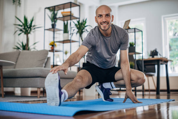 istock Man exercising on the floor at home 1327637823