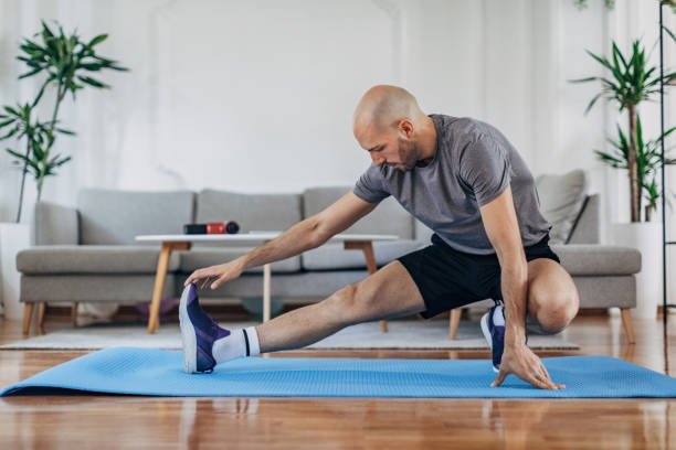 istock Man exercising on the floor at home 1327637979