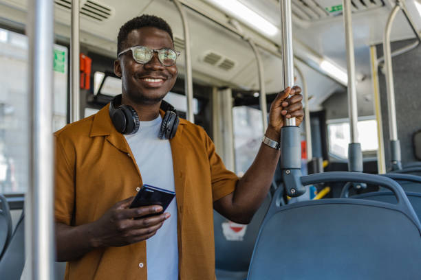 istock Confident young African-America in public transport using mobile phone 1327638560