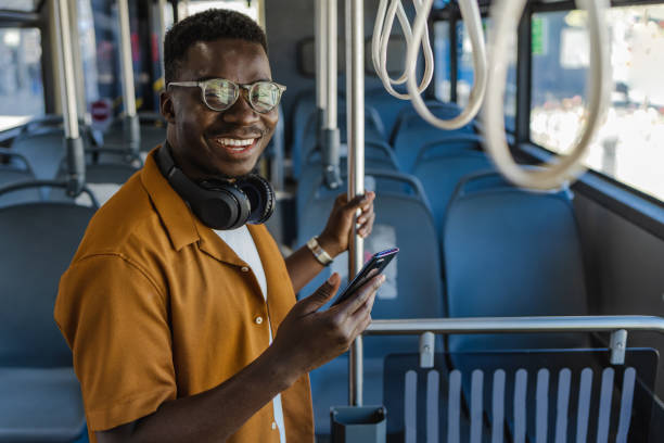 istock Confident young African-America in public transport using mobile phone 1327638729
