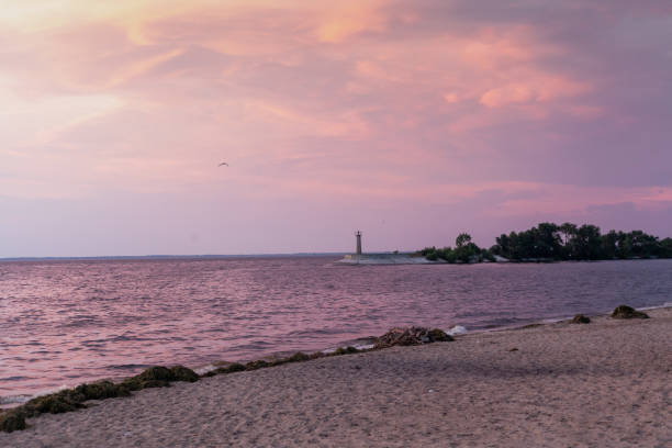 istock Picturesque seascape with lighthouse  sunset 1327640654