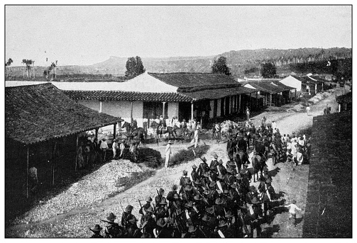 Antique black and white photograph of people from islands in the Caribbean and in the Pacific Ocean; Cuba, Hawaii, Philippines and others: American army of occupation entering the suburbs of Havana, Cuba