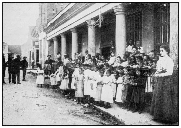 Antique black and white photograph of people from islands in the Caribbean and in the Pacific Ocean; Cuba, Hawaii, Philippines and others: Public School, Havana, Cuba