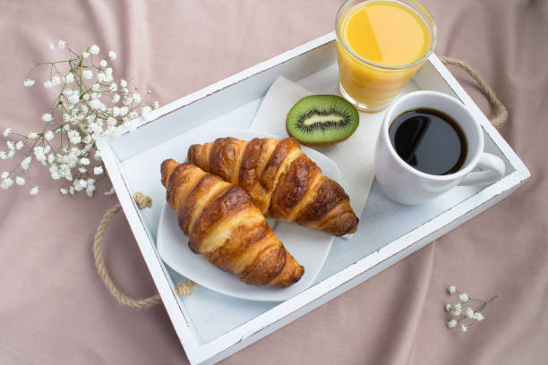istock Breakfast in the bed on the white wooden tray 1327649117