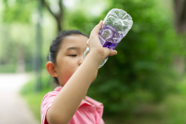 istock Little Girl Drinking Water 1327649331