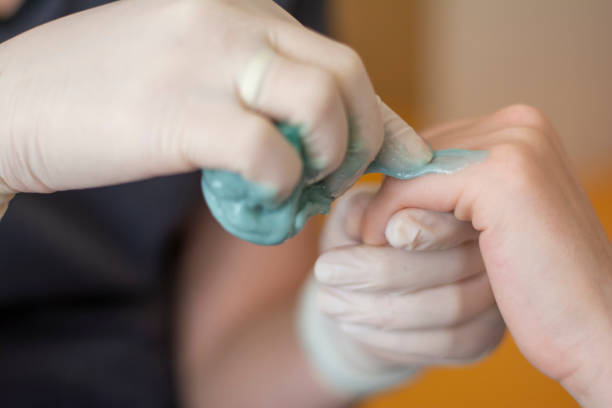 istock Applying the master sugar paste to depilation on the leg 1327649422