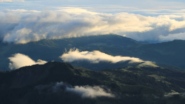 istock Sun lit clouds over green hills in Entlebuch, Switzerland. 1327650631