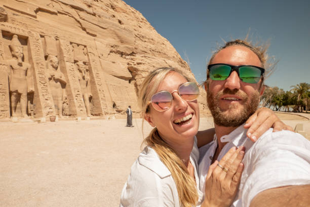 istock Couple travel in Egypt, take selfie with ancient temple 1327651717