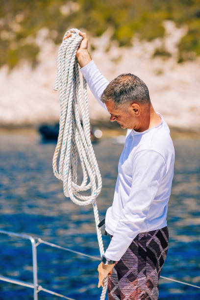 istock Sailor preparing rope on sailboat 1327651889