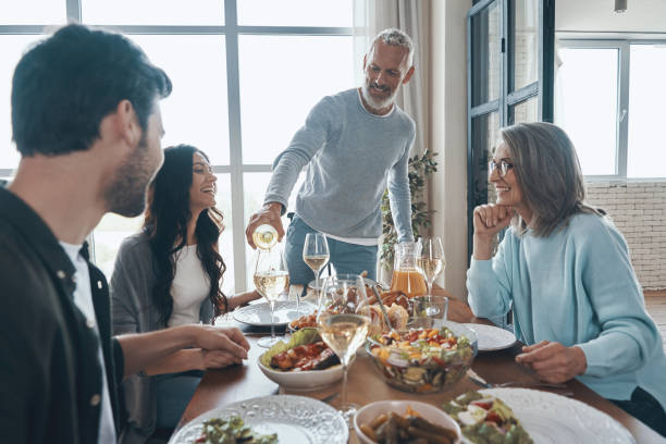 istock Happy senior man poring wine and smiling 1327652461