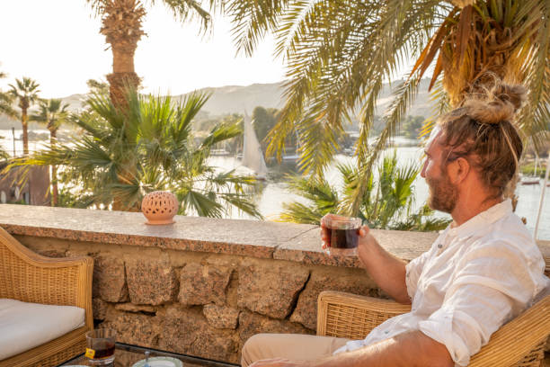 istock Man enjoys high tea by the Nile river in Aswan 1327653086