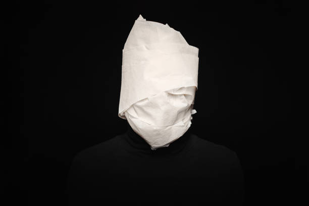 istock Man head wrapped in toilet paper 1327653187