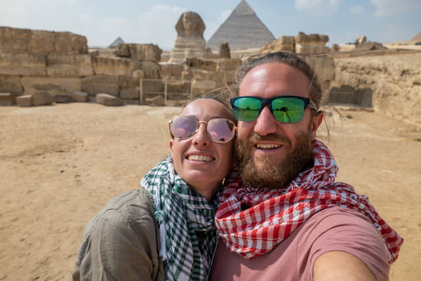 istock Couple take selfie at the pyramids, Egypt 1327653483