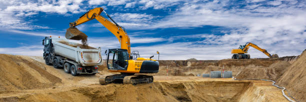 istock earth mover and excavator at work in construction site 1327653627