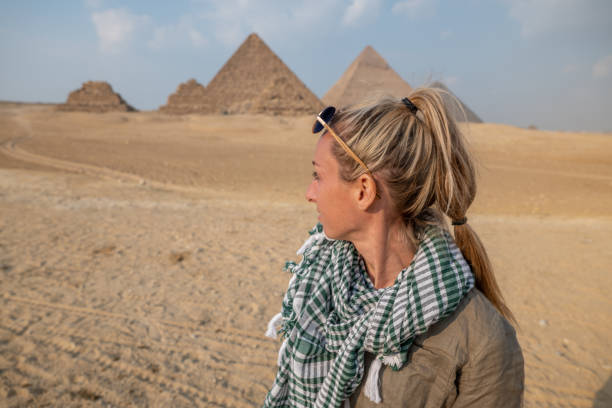 istock Woman contemplates the Pyramids in Egypt 1327653966