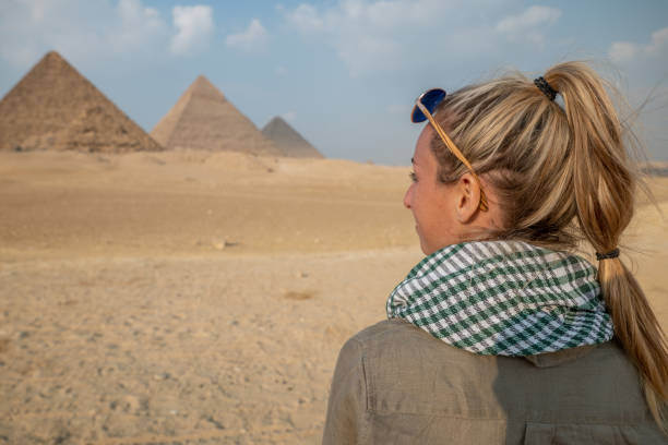 istock Woman contemplates the Pyramids in Egypt 1327654255