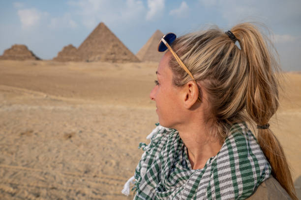 istock Woman contemplates the Pyramids in Egypt 1327654914