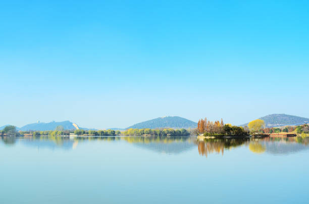 istock Plants and mountains reflected on clear lake, beautiful natural landscape, panoramic view 1327657760
