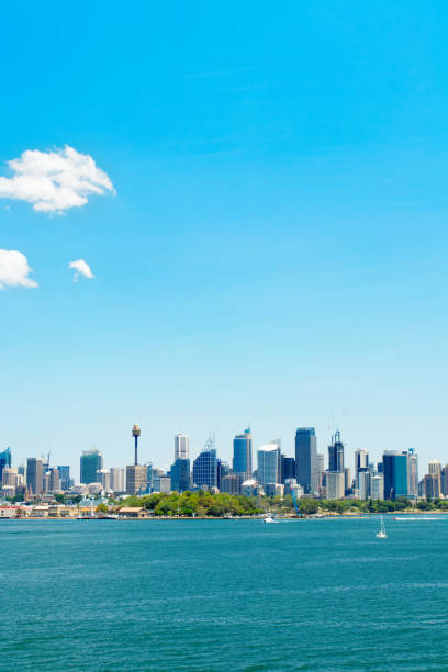 istock Modern city beside the blue sea under blue sky and white clouds. Panoramic view 1327657849