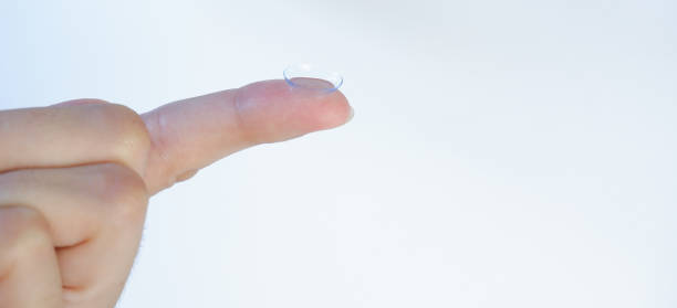 istock Contact lens on finger on a blue background 1327658173
