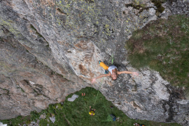 istock Drone view of mountain climber ascending rock face 1327659712