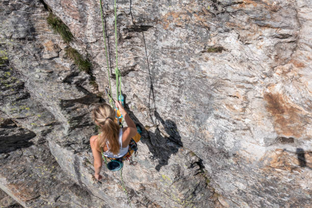 istock Drone view of mountain climber ascending rock face 1327659843