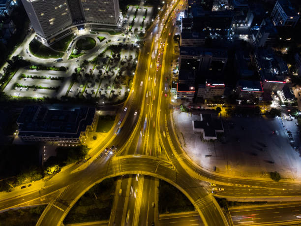 istock Car light trails at a traffic roundabout 1327659882