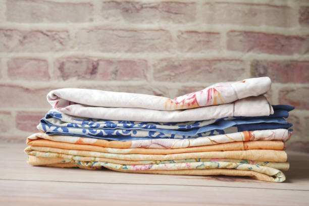 istock close up of stack of clothes on table . 1327660075