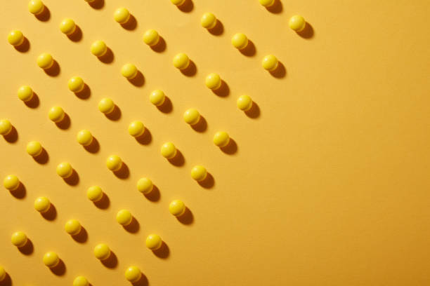 Yellow Chocolate candies on yellow Colored paper background