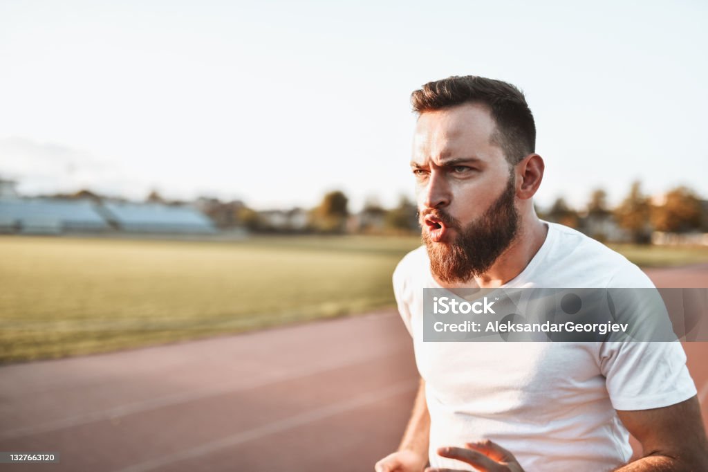 Male Athlete Determined To Perform Well On Running Track Active Lifestyle Stock Photo