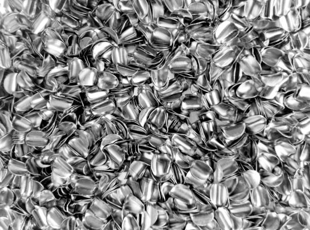 aluminum metal flakes a bunch of small pieces of aluminum metal . unused industrial waste material tin foil barb stock pictures, royalty-free photos & images